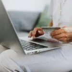 woman using macbook browsing an ecommerce website made with woocommerce