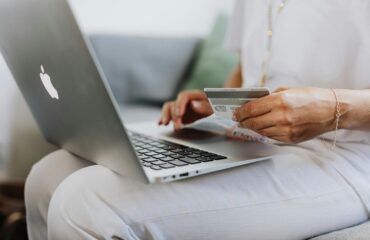 woman using macbook browsing an ecommerce website made with woocommerce